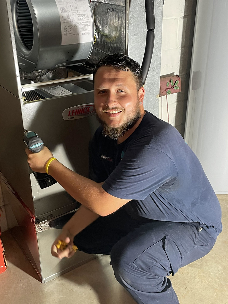 HVAC technician servicing an air conditioning unit