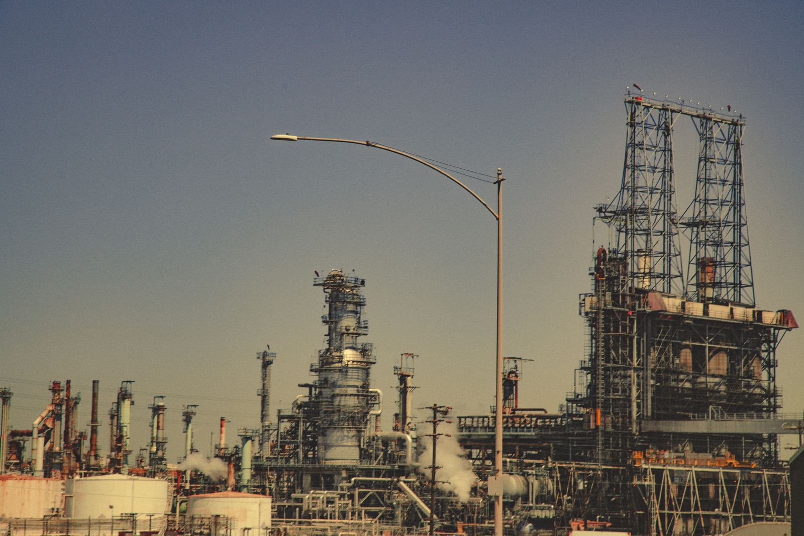 Industrial refinery with pipes and towers under a clear sky