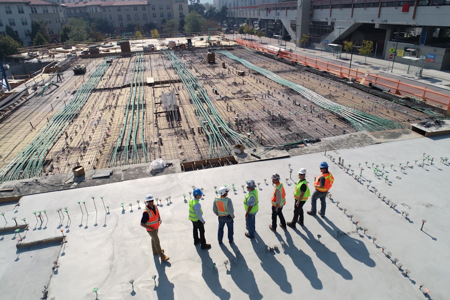 Team of site workers in safety vests and helmets on a rooftop