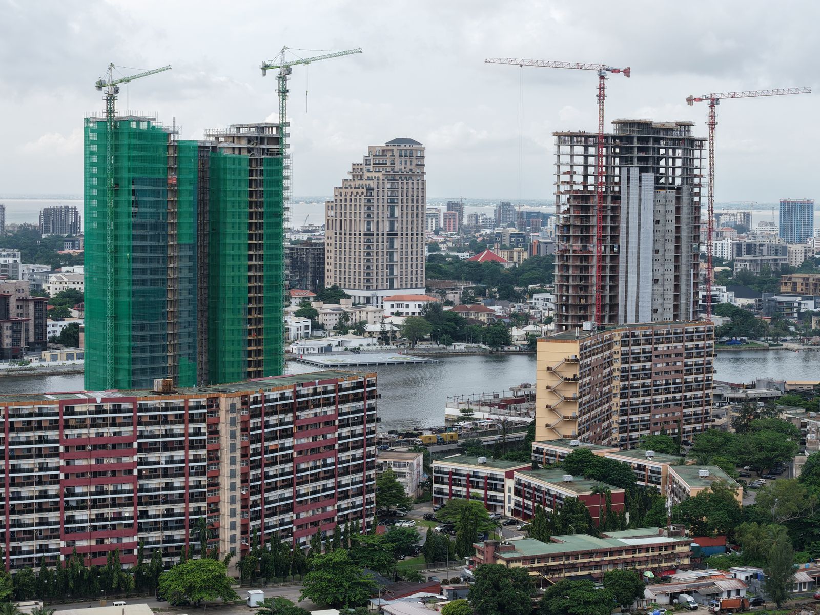 Aerial view of high-rise towers under construction along a waterfront