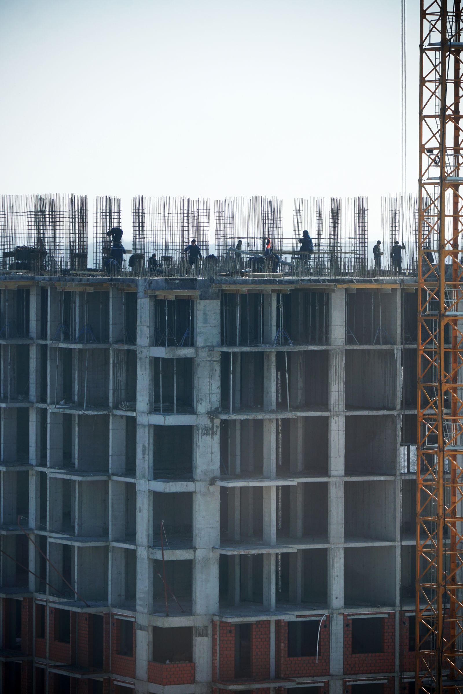 Construction workers building a high-rise tower structure