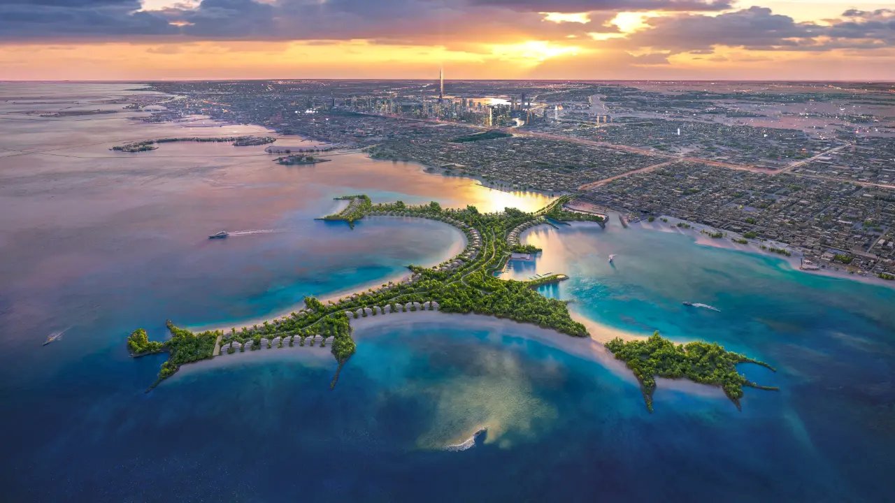 Aerial view of a coastal island development at sunset