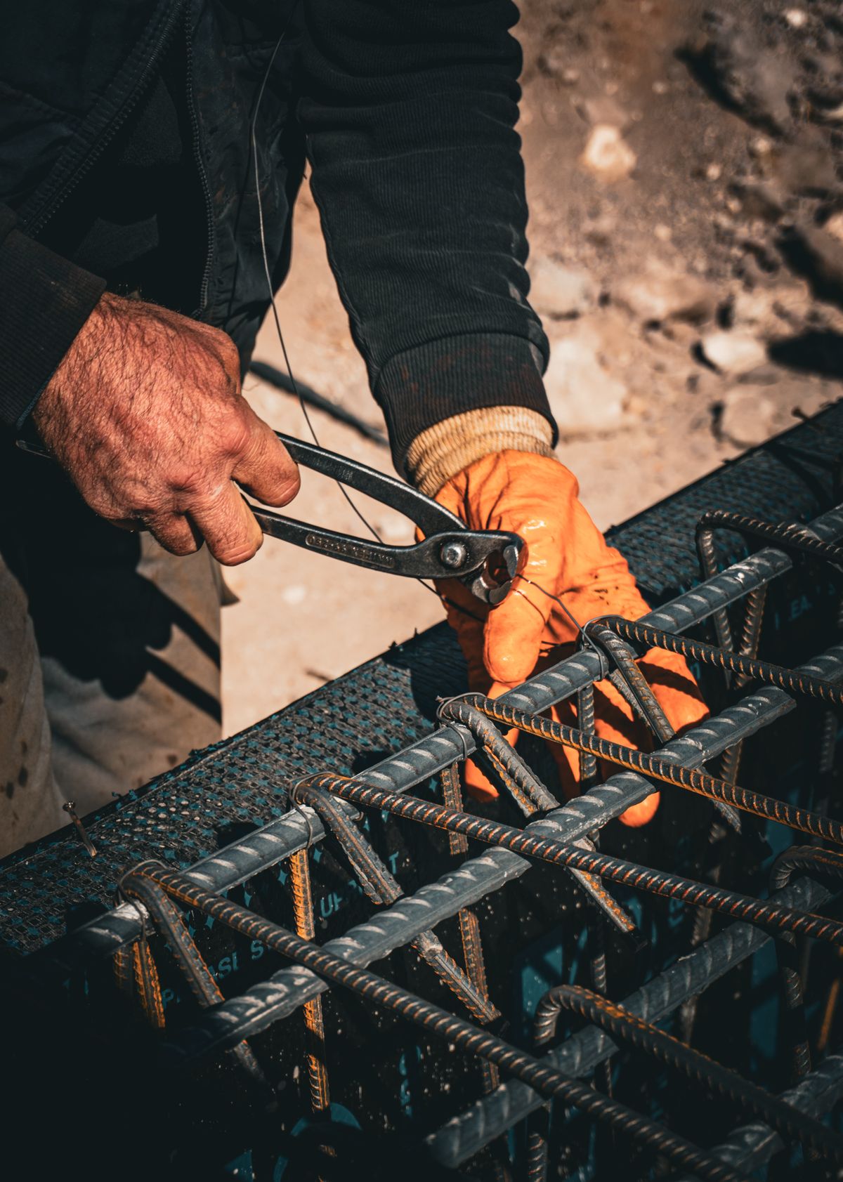 Steel fixer tying reinforcement bars with pliers